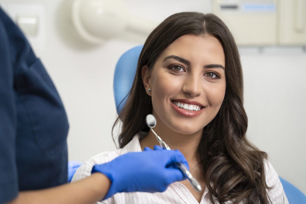 young woman smiling during a dental exam